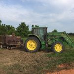 Close up of tractor with trailer of planting supplies