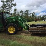 Tractor working in hay field